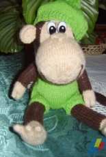 Naughty monkey in a beret-green apple