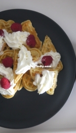 Breakfast: waffles with whipped cream and raspberries